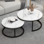 Modern white marble nesting coffee table with black steel base in a minimalist living room