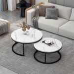 Modern white marble nesting coffee table with black steel base in a minimalist living room