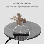 Modern white marble nesting coffee table with black steel base in a minimalist living room