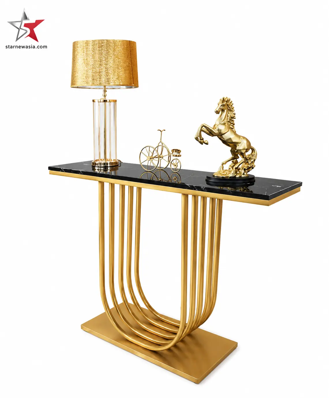 starnewasia.com watermark on a narrow black marble console table featuring a polished gold U-shaped stacked pipe base, styled with a golden table lamp and a rearing horse sculpture.