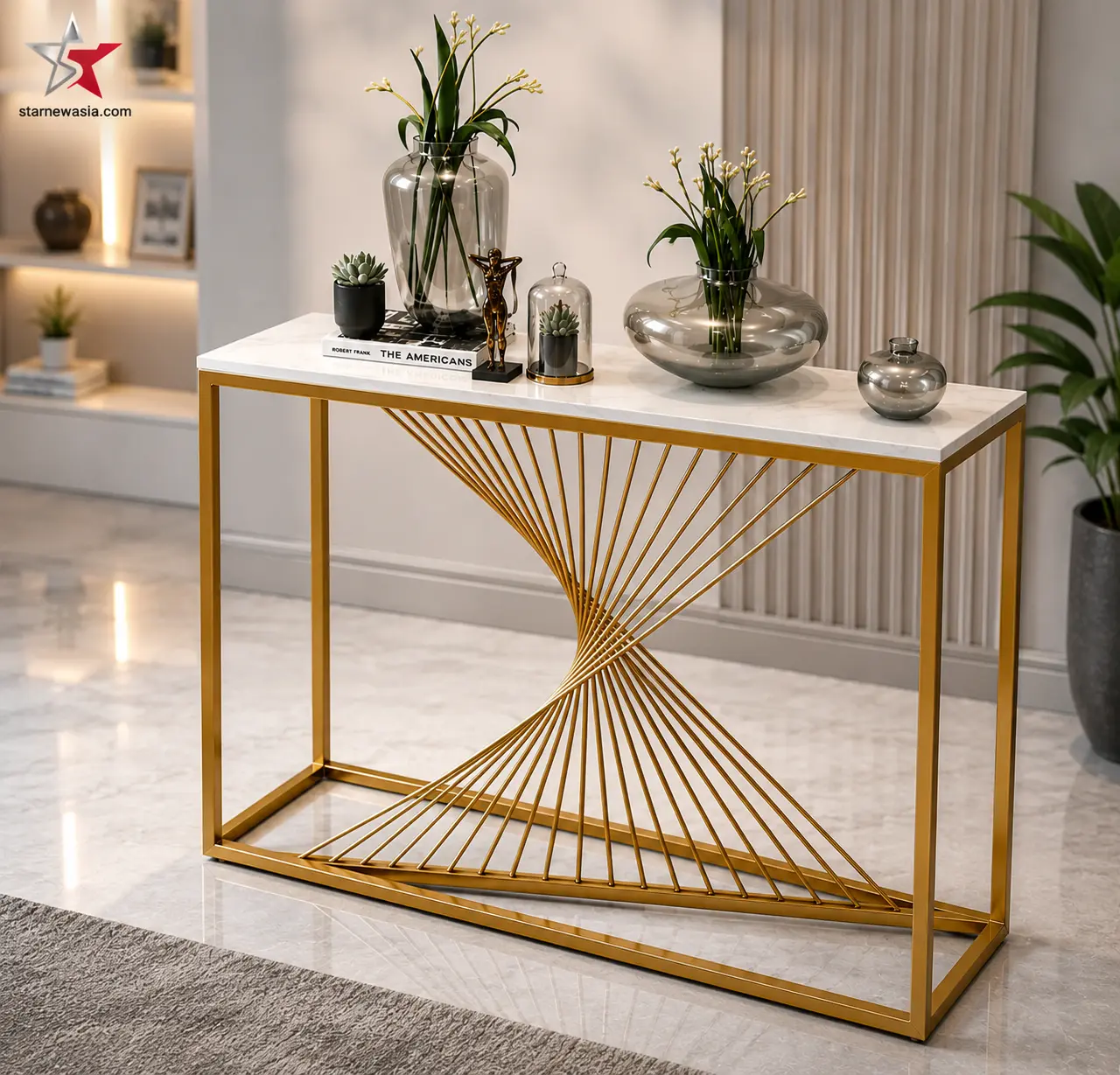 starnewasia.com watermark on a gold geometric spiral console table with a white marble top, styled with botanical glass vases and books.