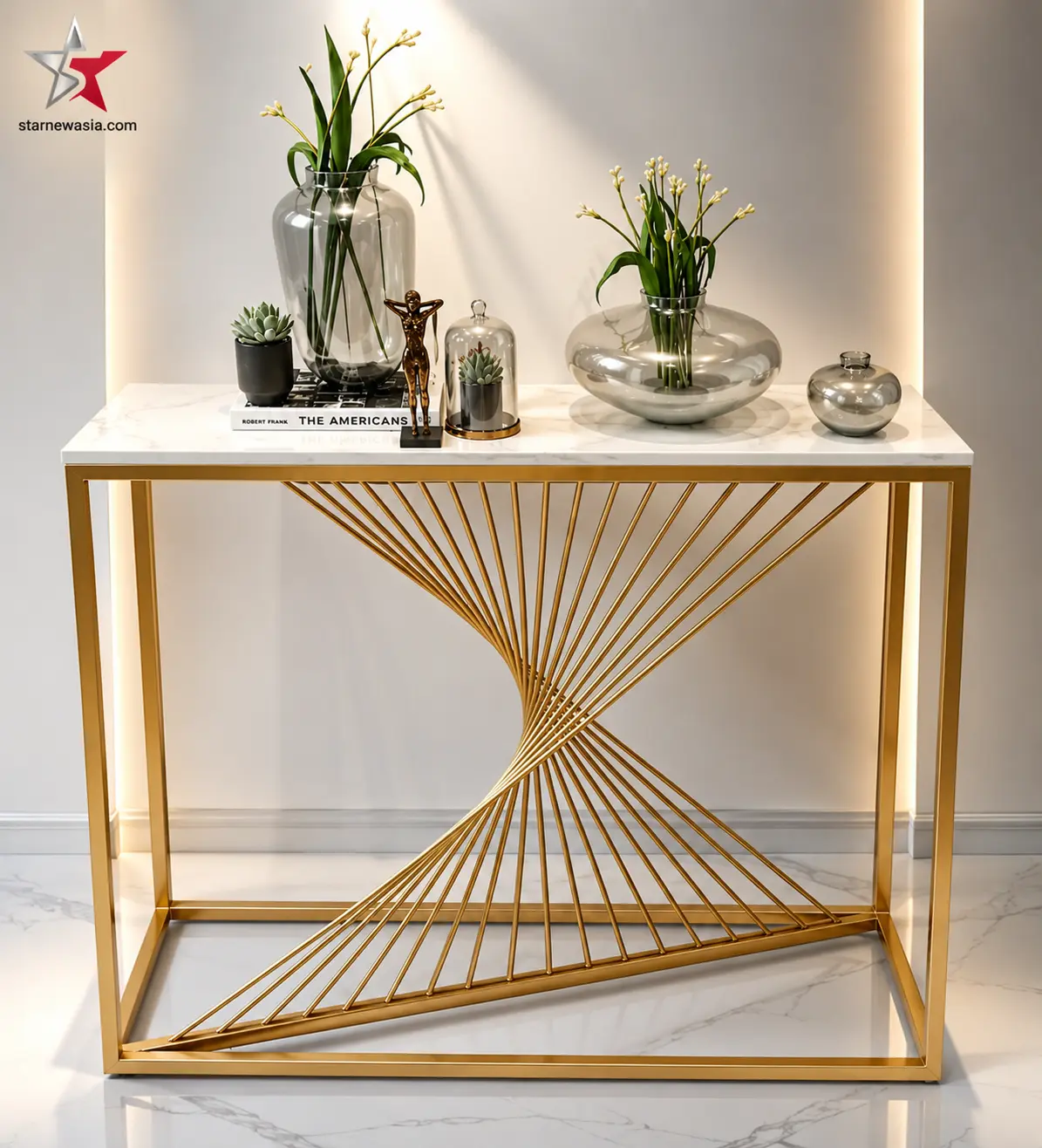 starnewasia.com watermark on a gold geometric spiral console table with a white marble top, styled with botanical glass vases and books.