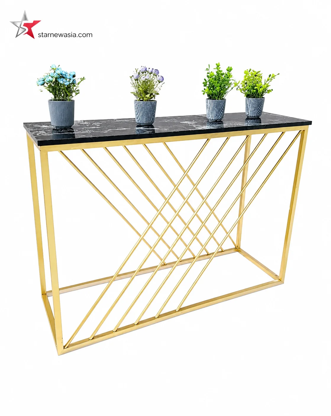 starnewasia.com watermark on a luxury gold console table with an asymmetrical geometric crossbar frame and a dark stone top, styled with small potted green plants.